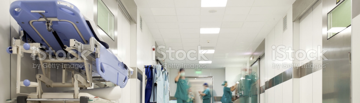Blurred figures of people with medical uniforms in hospital corridor